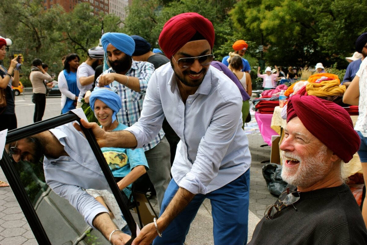 A man tries on a Sikh turban at a Kaufman event